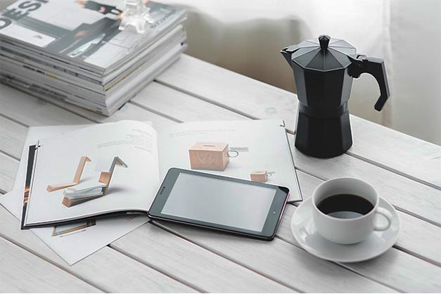 pitcher tablet books on desk top with window light