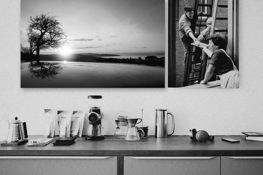 Black and white canvas prints hanging above a kitchen counter without frames or glass