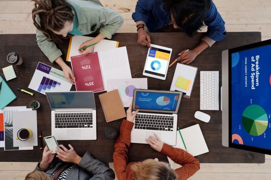 Marketing team reviewing reports and analytics on laptops while planning a content marketing strategy
