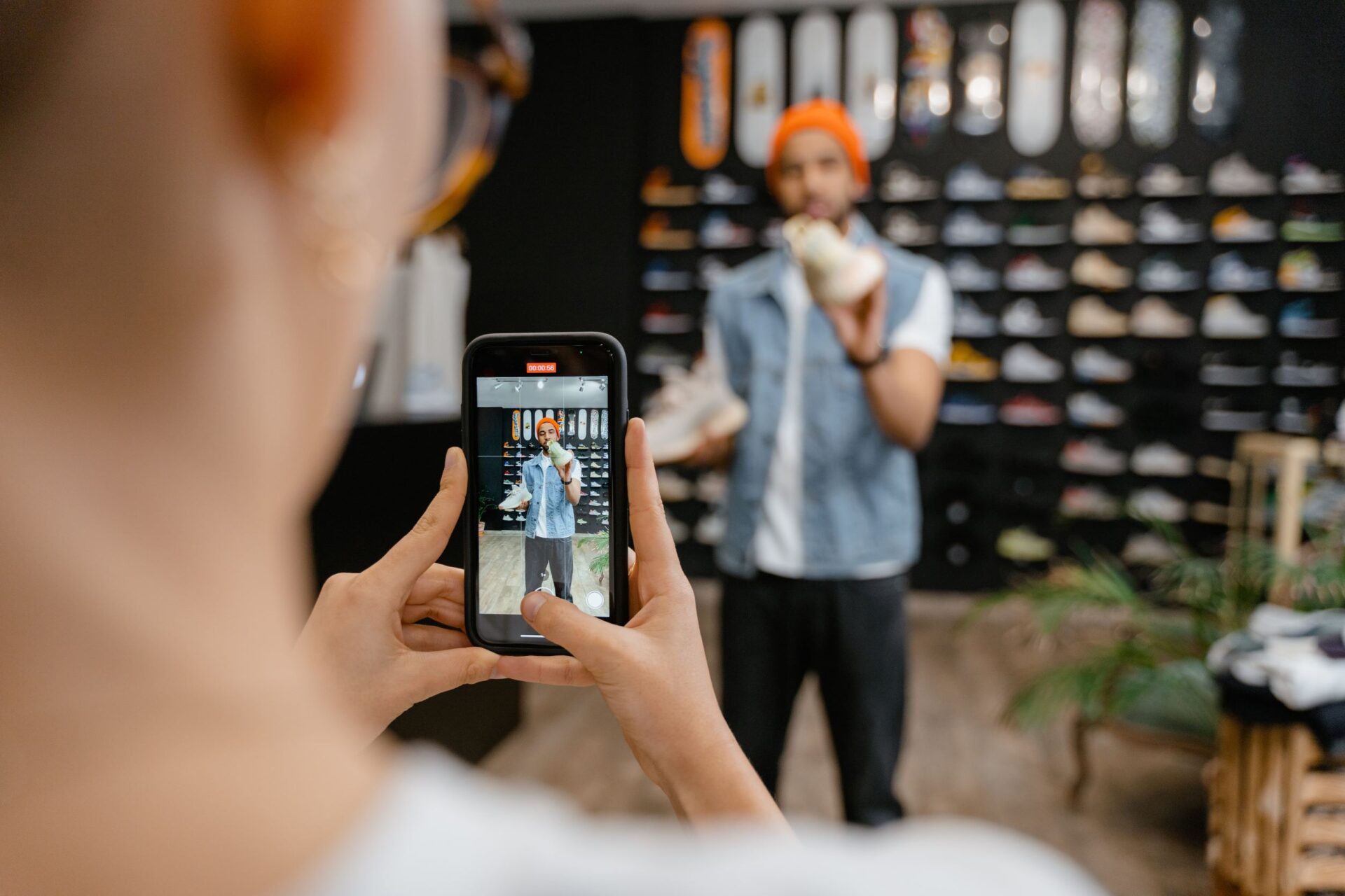 Small business owner filming a product video on a phone to promote an online store