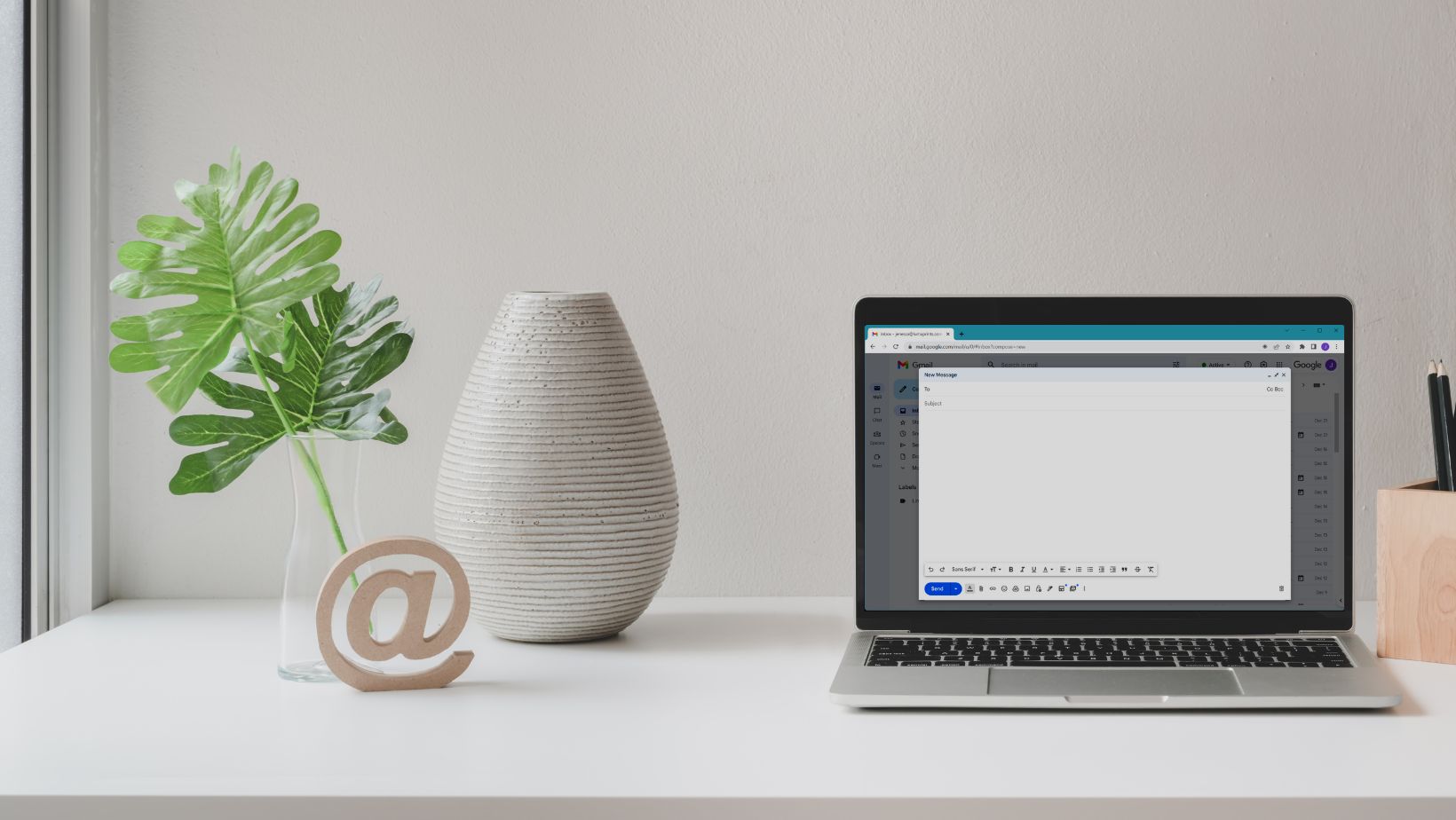 Laptop showing a blank email compose window with the subject field, used to write email subject lines