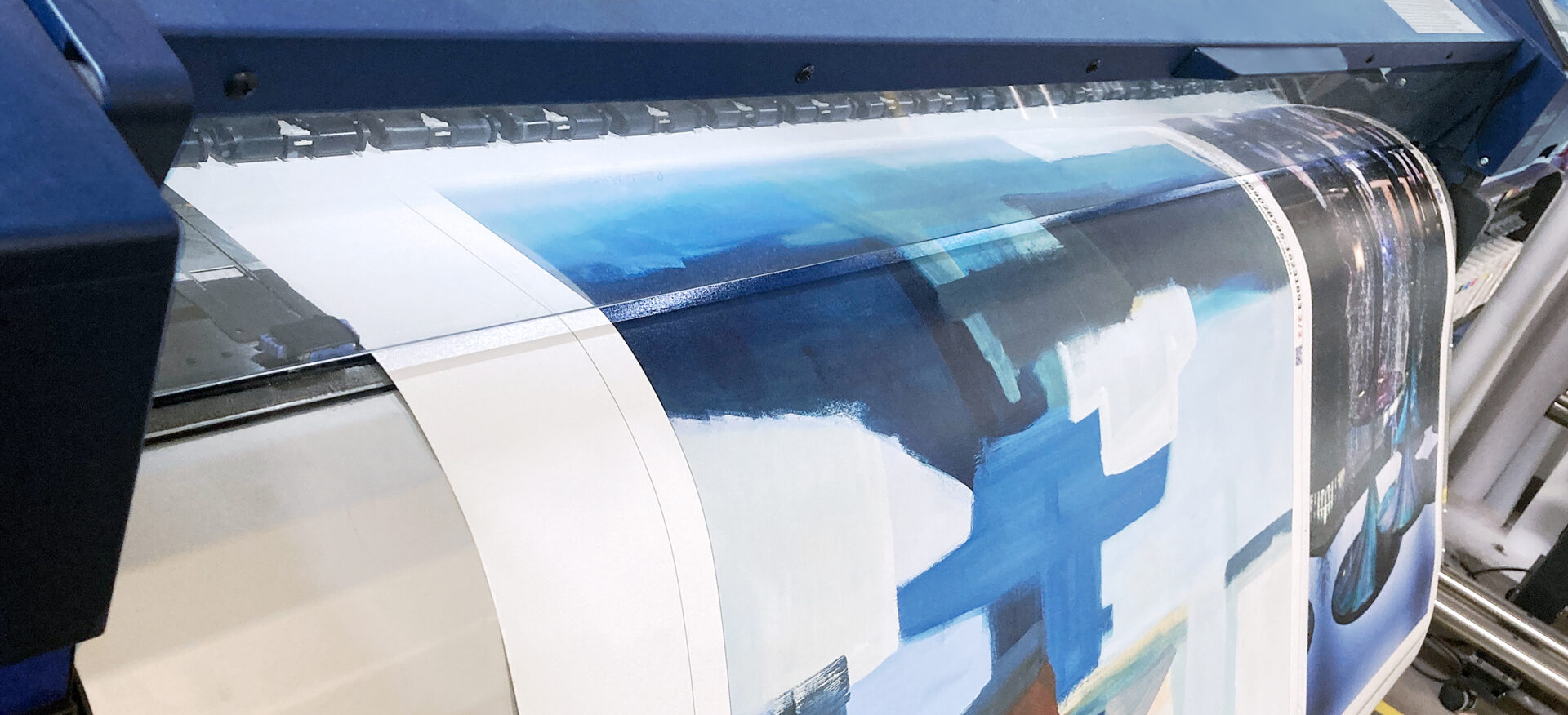 Large format printer producing an abstract art reproduction on canvas material