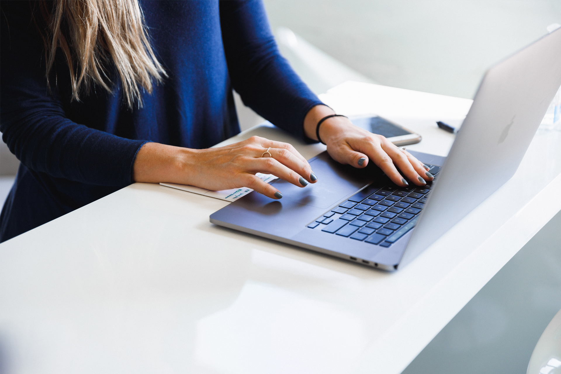 Person working on a laptop preparing print-ready image files with the correct resolution and color profile