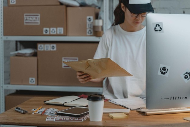 A woman sorting through packages.