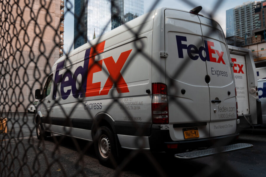 Courier delivery van parked in a city street, representing carrier options for shipping artwork