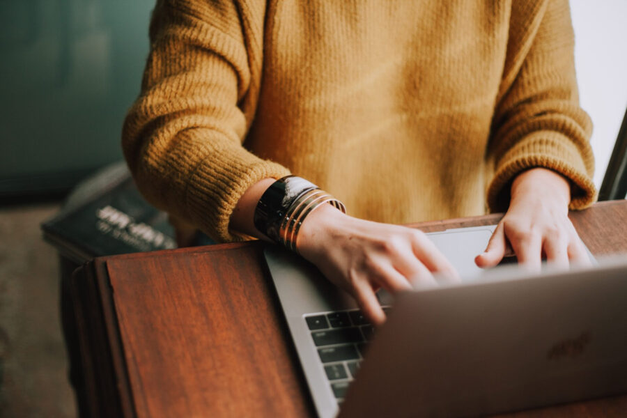 Seller working on a laptop while managing product listings across online marketplaces