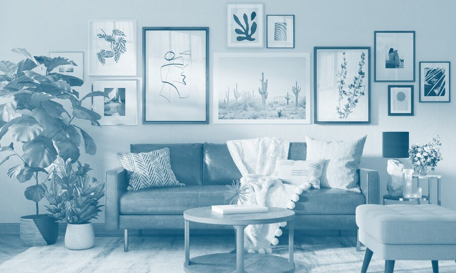 Gallery wall of framed art prints above a sofa, showing home decor demand in print on demand