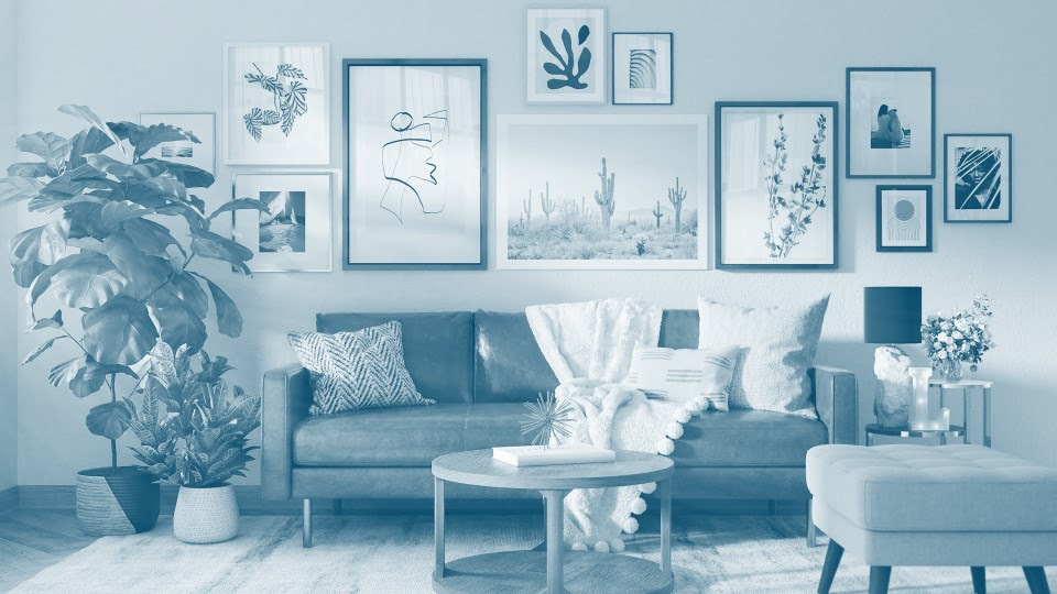 Gallery wall of framed art prints above a sofa, showing home decor demand in print on demand