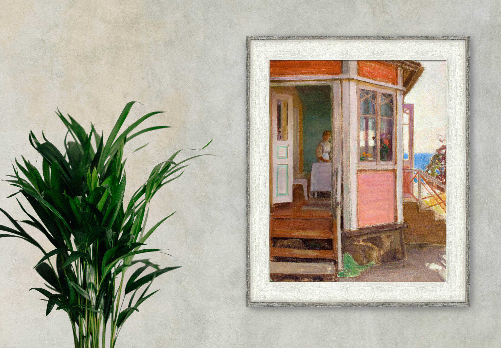 Classic painting in a whitewashed wood frame hanging on a neutral wall beside a green palm plant