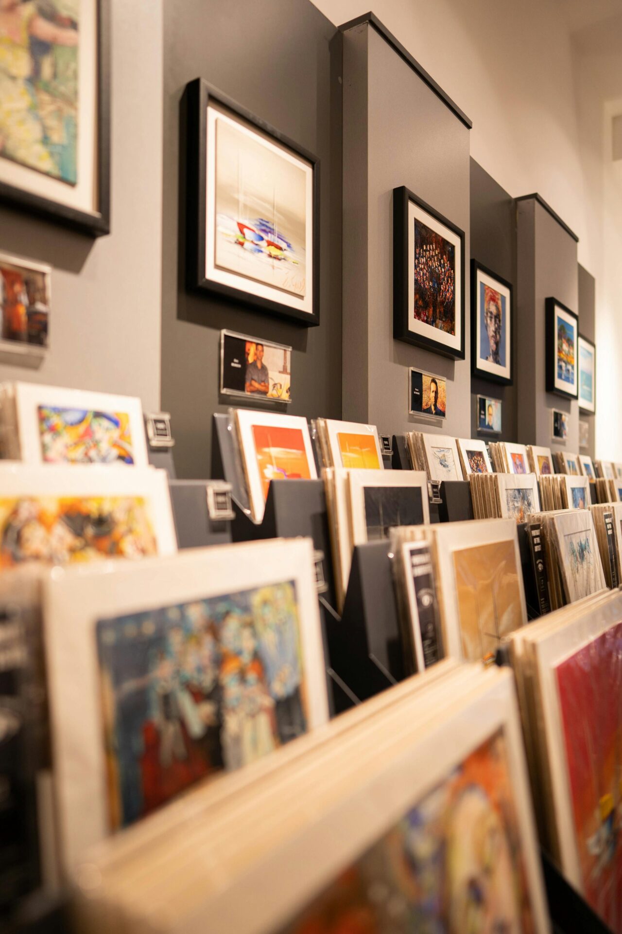 Art gallery display featuring framed wall art and rows of art prints for sale