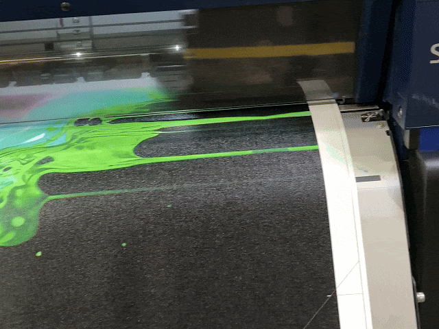 Large-format printer producing a vivid green and black custom art print