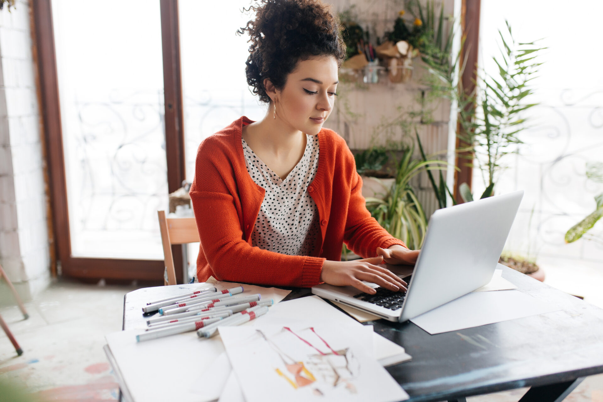 Artist using a laptop to set up an ecommerce store for selling print-on-demand artwork
