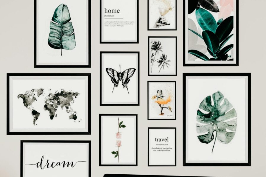 Gallery wall featuring framed botanical prints, typography, maps, and nature-inspired artwork