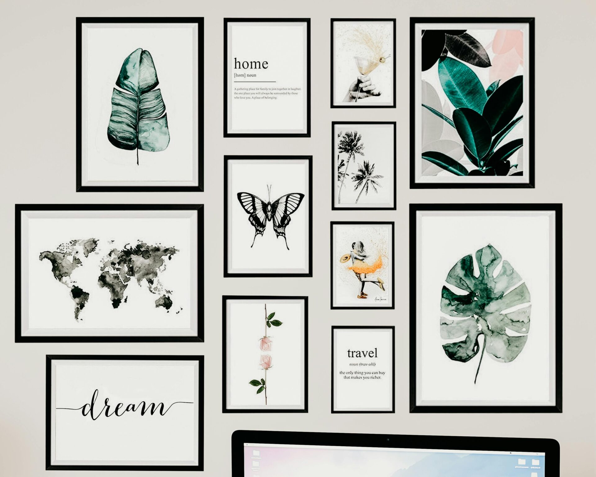 Gallery wall featuring framed botanical prints, typography, maps, and nature-inspired artwork