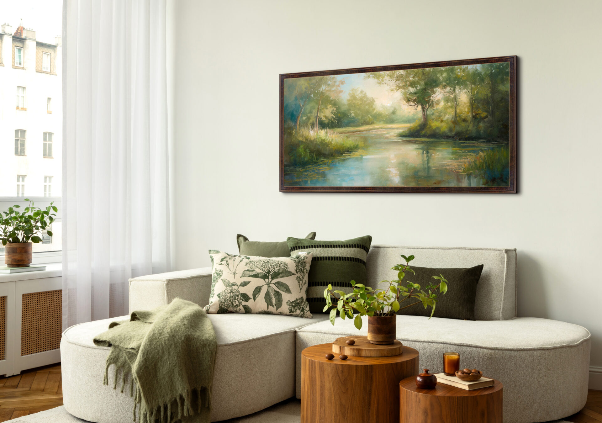 Framed landscape artwork displayed above a neutral sofa in a bright modern living room