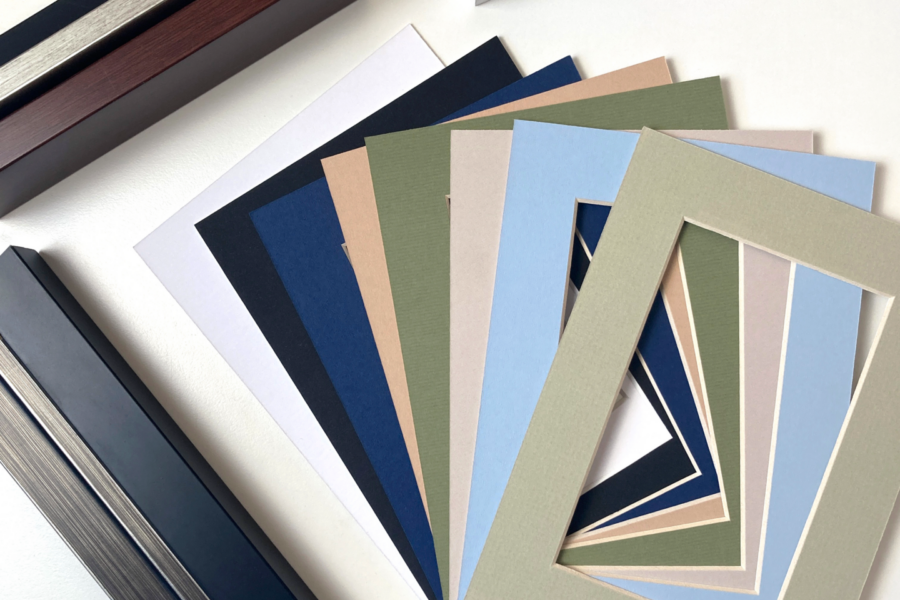 Frame corner samples and colored mat boards laid out for customizing the presentation of wall art